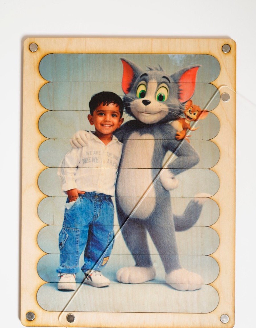 FixMe personalised wooden puzzle — child posing with Tom & Jerry, printed on wooden sticks in a magnetic frame